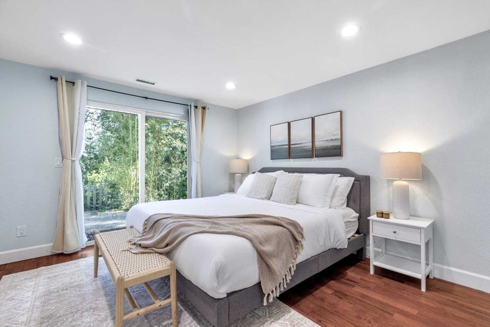 Unwind in this spacious bedroom featuring a comfortable king-sized bed and calming views.
