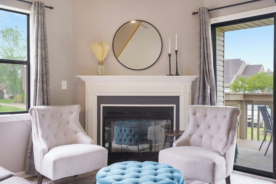 Open living space with sofa sleeper, Smart TV, and electric fireplace