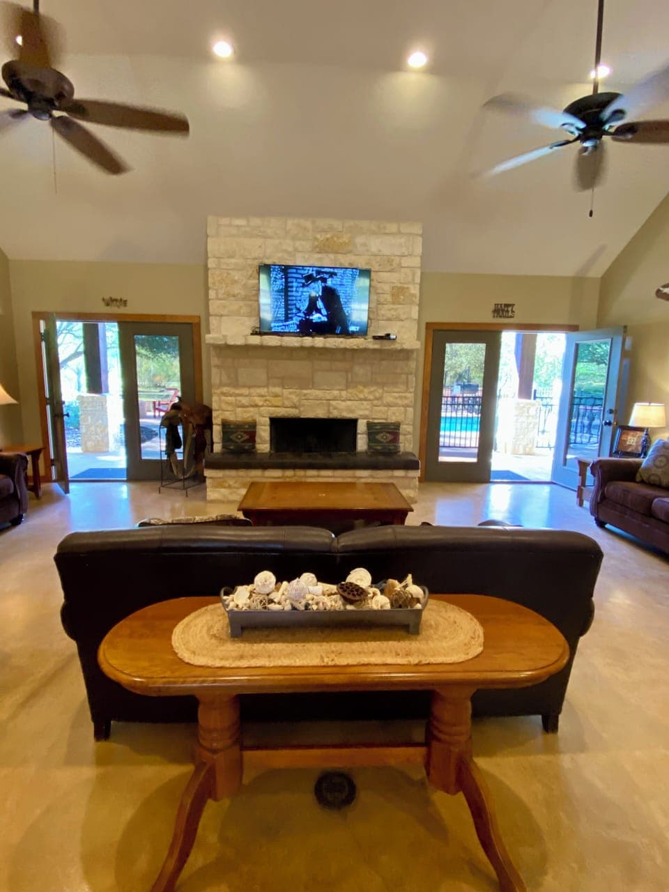 COPA VINO - The great room has a floor-to-ceiling, wood burning, white rock fireplace flanked by 2 french doors overlooking the pool.