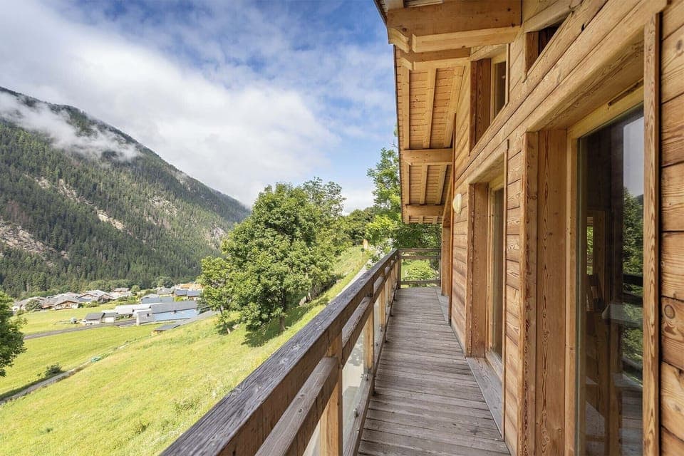 Step out onto the spacious wooden balcony and take in the breathtaking views of the surrounding mountains.