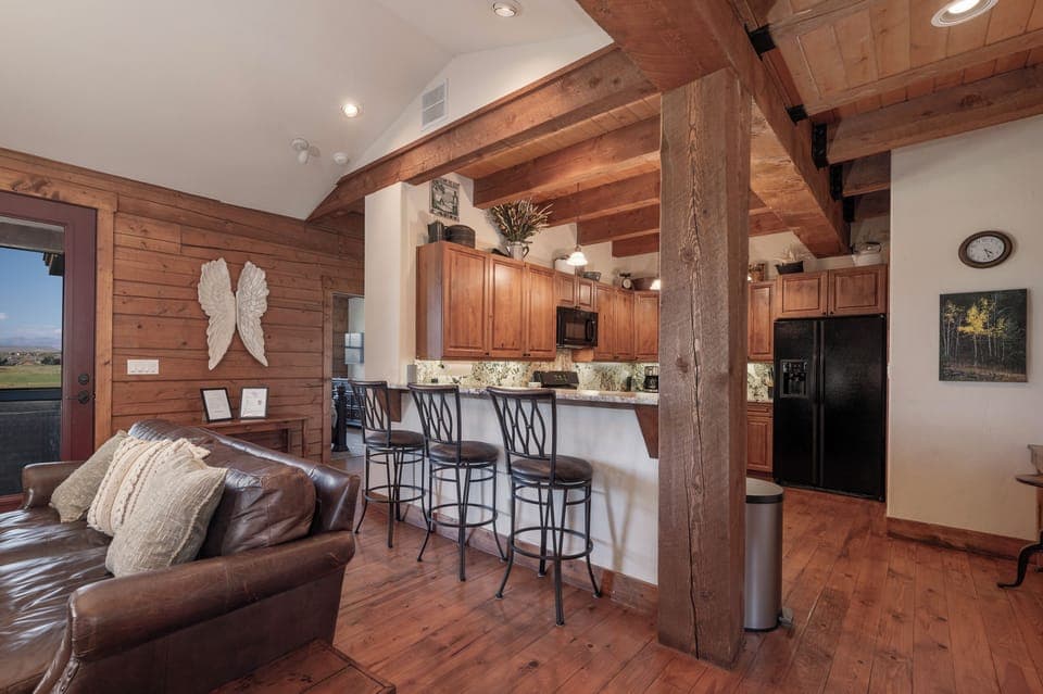 - Open kitchen bar with seating for casual morning coffee   - Spacious wood interior flows into living room area   - Great spot for family chats and relaxed dining moments
