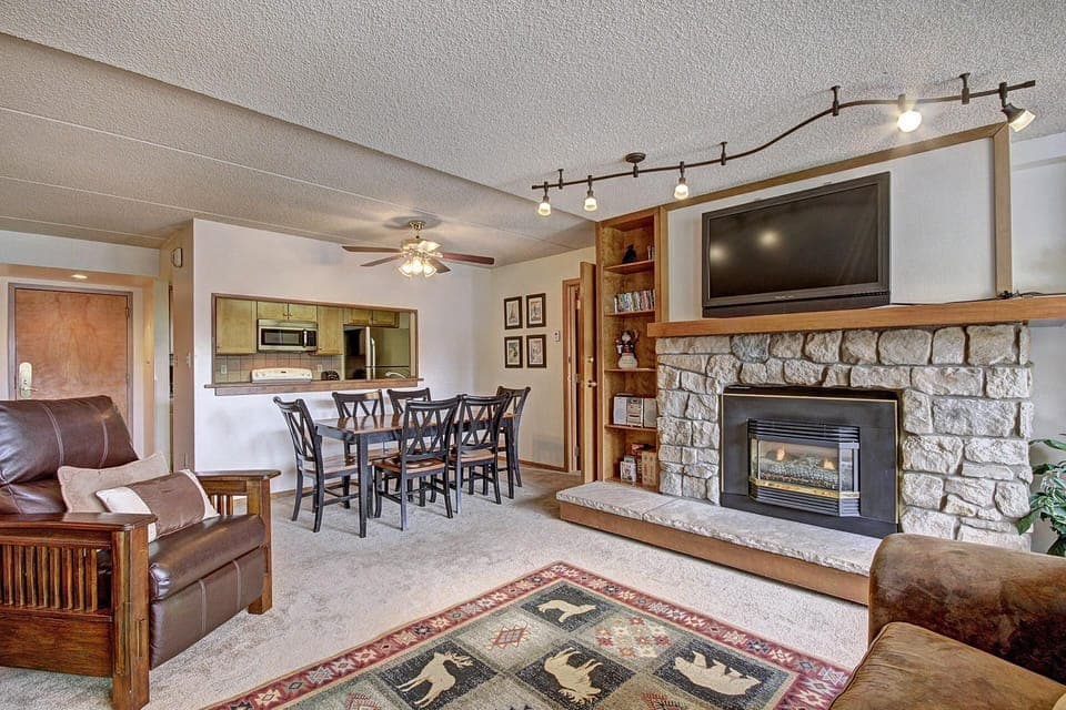 Open concept living and dining room table, fireplace, and TV