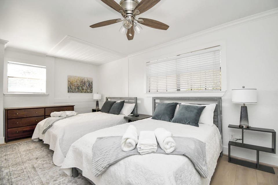 Relax in this spacious bedroom featuring two full beds, ideal for a comfortable stay with family or friends.