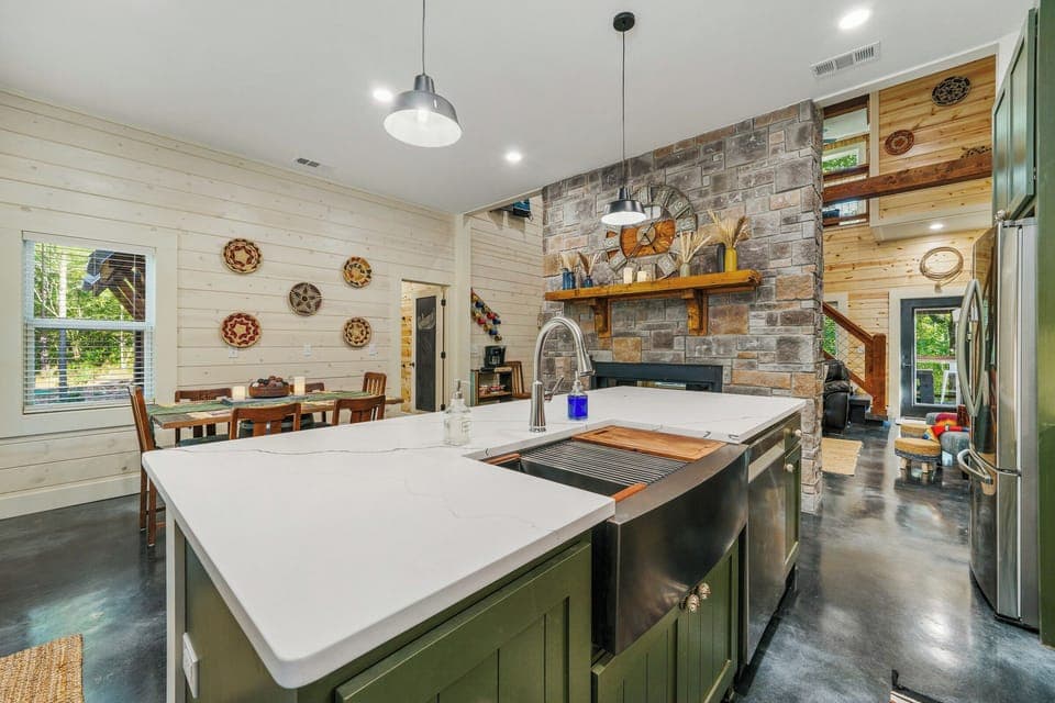 Modern kitchen with stone fireplace and spacious dining area