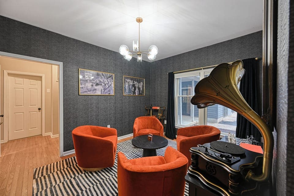 Step into the charm of the speakeasy room, a cozy and stylish retreat perfect for unwinding with friends and family. Challenge someone to a game of darts or pour a drink. Whether you're enjoying a relaxed evening of conversation or music, this space is designed for memorable moments.