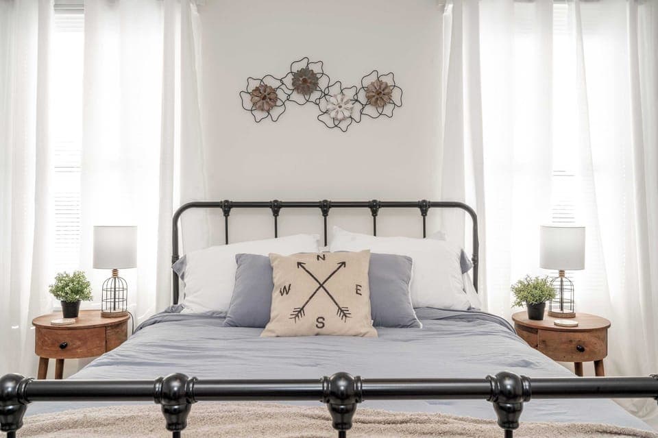 A comfy queen-sized bed awaits in the breezy bedroom sanctuary