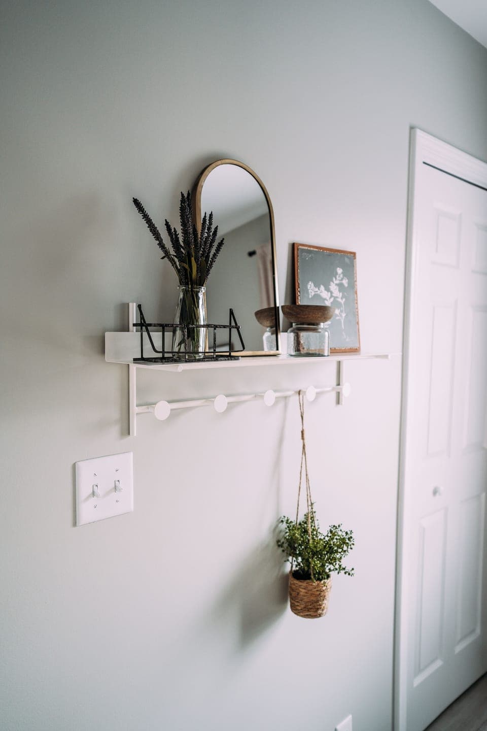 Stylish mirror and greenery add a touch of elegance to your arrival.