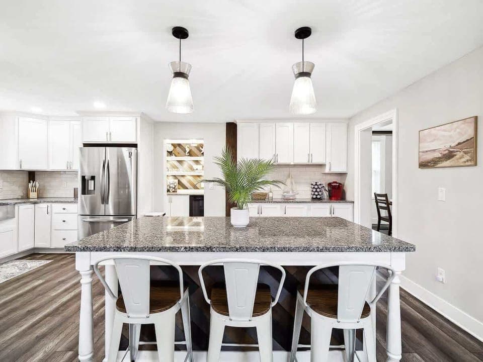✨ Whip up your favorite meals in this stunning, fully stocked kitchen featuring granite countertops, stainless steel appliances, and a spacious island perfect for gathering!
