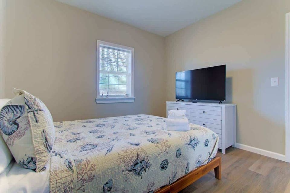 Relax and recharge in this beach-inspired bedroom, perfect for winding down after a day of adventure. 