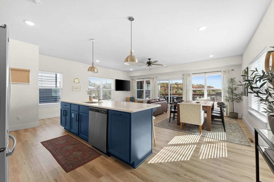 The kitchen and dining area flow into the main living room; creating an open-concept layout that's perfect for a large group to be able to gather in one place!