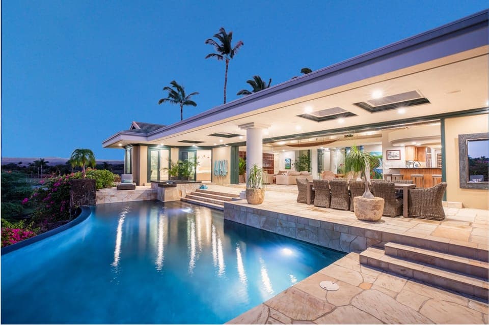 A luxurious infinity‑edge pool set against ocean skyline and palm trees — your private island escape begins here.