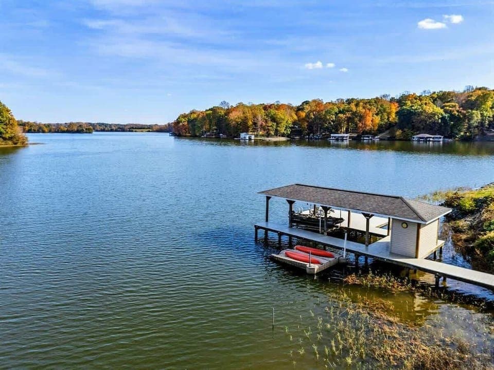 Peaceful lakefront dock with covered storage and kayak access, perfect for water activities and relaxation