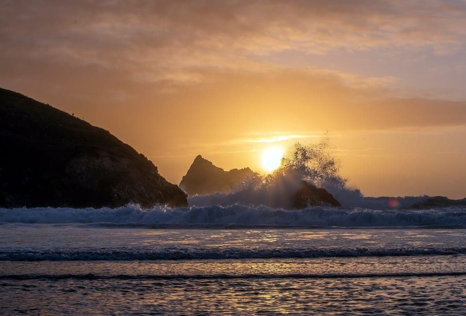 Watch the waves crash at sunset on the beach