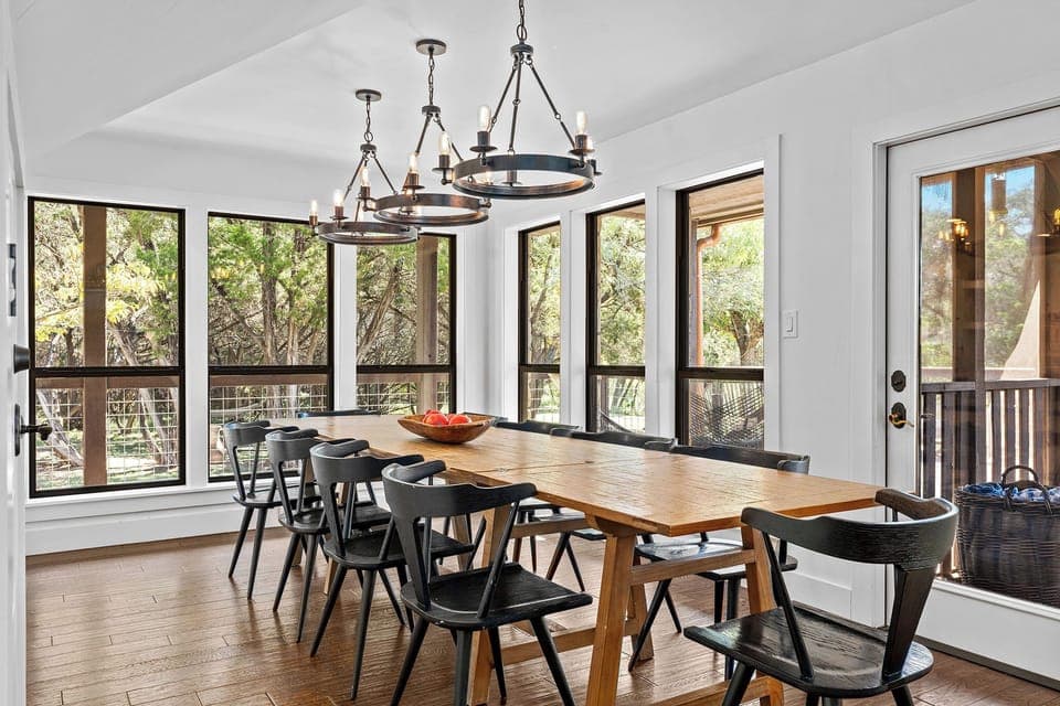Dine together at the oversized table, surrounded by natural light from large windows. This space makes every meal feel special.