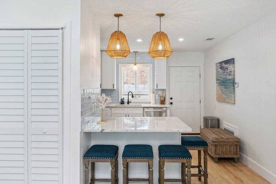 Chic chairs and a modern countertop create a perfect gathering spot.