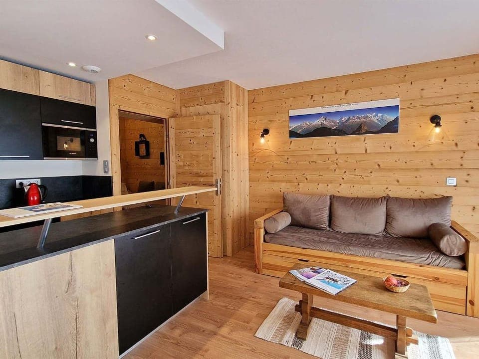 Cosy and welcoming living space with rustic wooden accents, located just 100 meters from the pistes, lifts, and tourism office — perfect for relaxing after a day on the mountain.