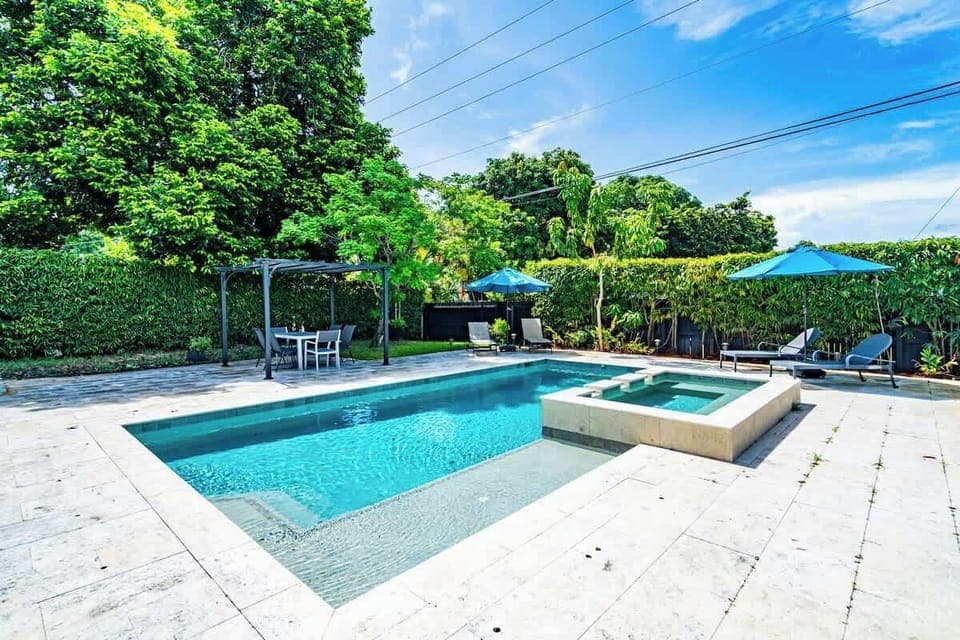 "Unwind in this private Airbnb oasis—sparkling pool, relaxing hot tub, and shaded dining under the pergola."