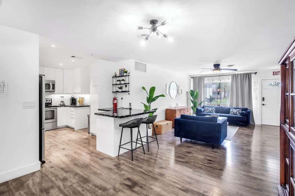 "Cook, dine, and unwind—this stylish Airbnb blends modern kitchen, cozy lounge, and natural light for effortless comfort."