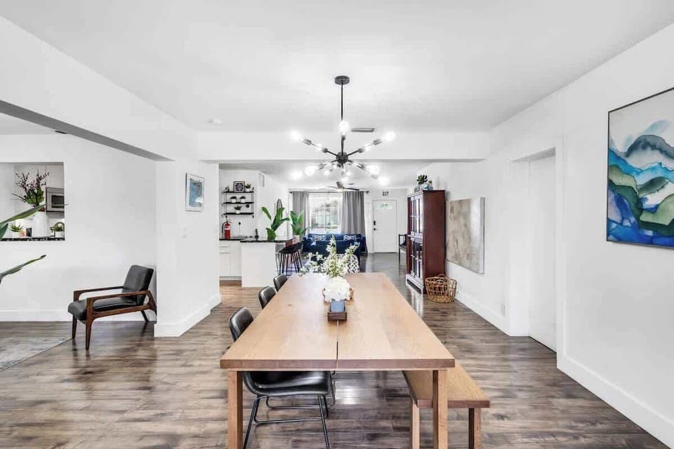 "Gather in style—this Airbnb features a sleek dining setup, modern art, and open-concept comfort."