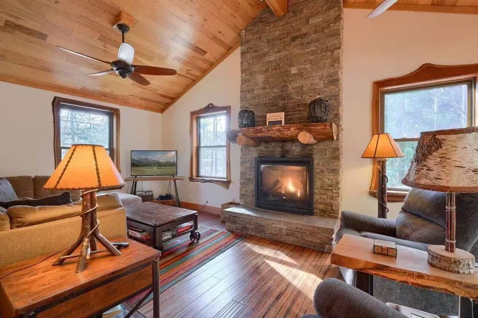 Main floor living room with cozy seating, gas fireplace, games, and books