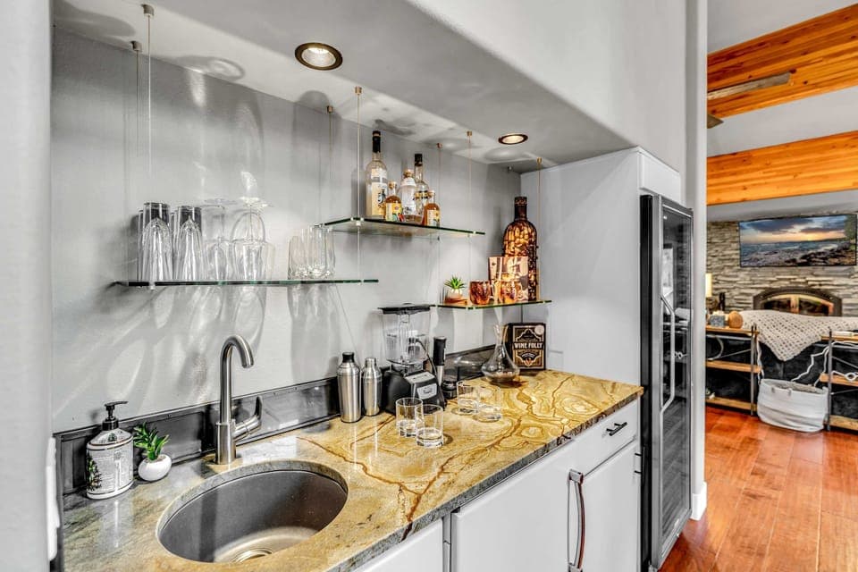 Dining Room: 6-person dining table, bar area, large wine fridge, adjacent to kitchen and living room