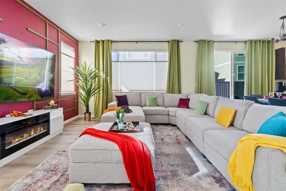 Welcoming living room featuring a cozy sectional sofa adorned with decorative pillows and throws, ideal for relaxation and comfort.