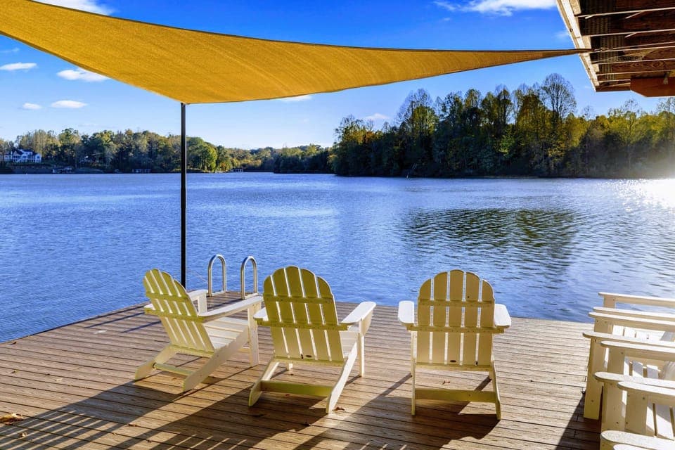 Dock - Adirondack chairs under the shade sail offer a front-row seat to the lake on a perfect bluebird day.