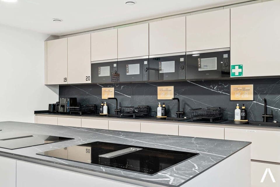 Modern Shared Kitchen with Island – Cook and connect in this sleek, fully equipped kitchen featuring premium appliances and a spacious island.