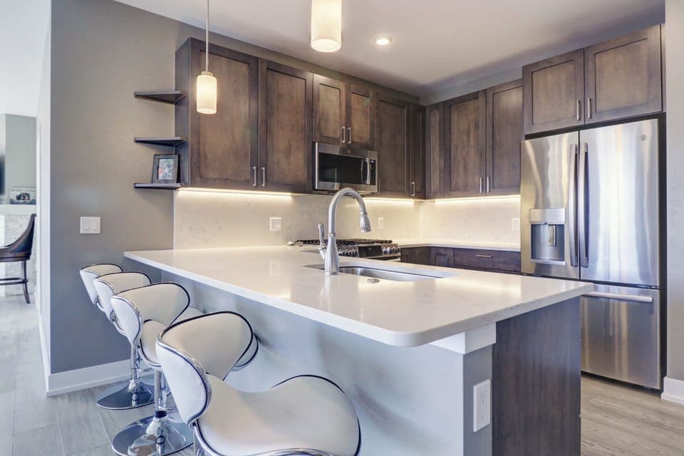 Modern condo features an updated kitchen with bar stool seating area.