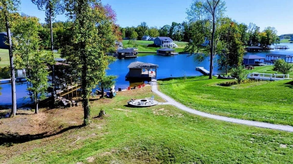 Unwind by the lakeside fire pit, surrounded by stunning water views and outdoor amenities for a perfect retreat.