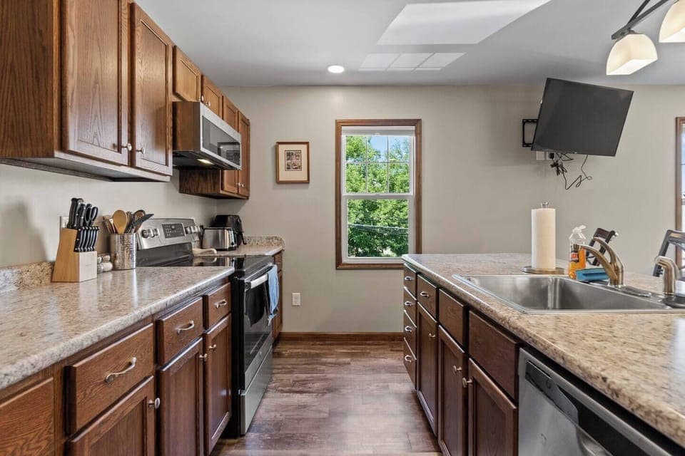 Fully equipped kitchen with a spacious countertop and ample cabinets, providing plenty of storage and space for all your cooking needs.