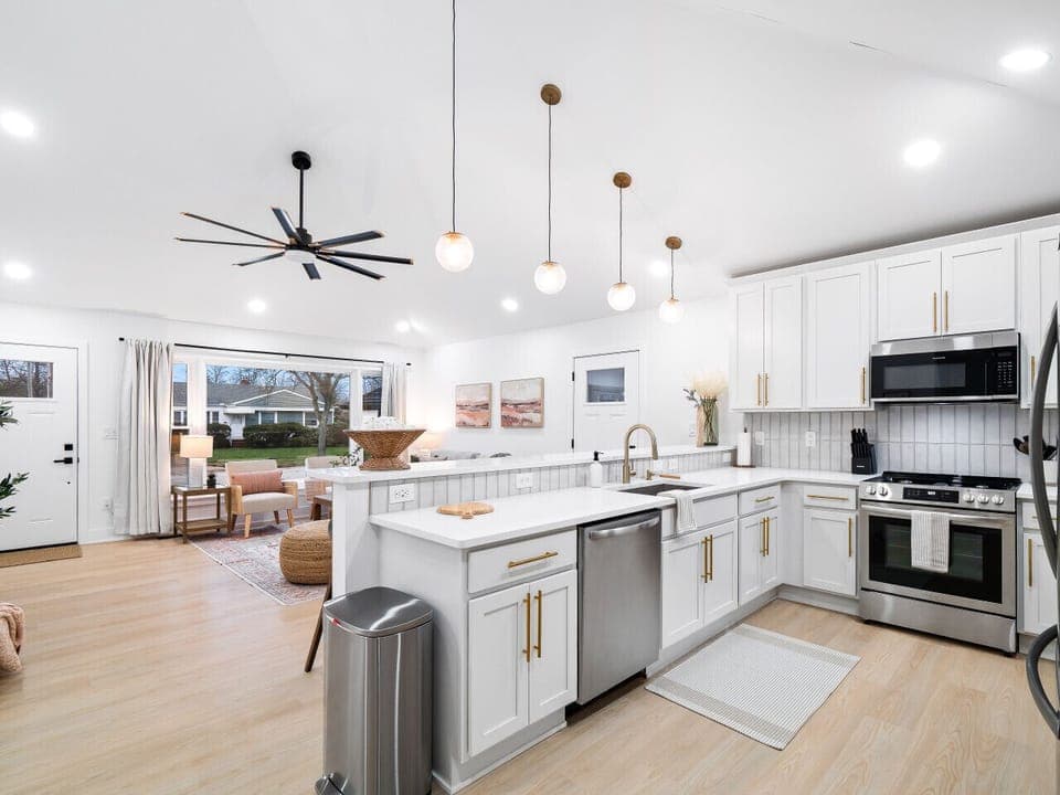 Sunshine streams into this dreamy kitchen, illuminating the crisp white cabinets and gleaming countertops.  Perfect for a cozy morning coffee ☕️. #dreamkitchen