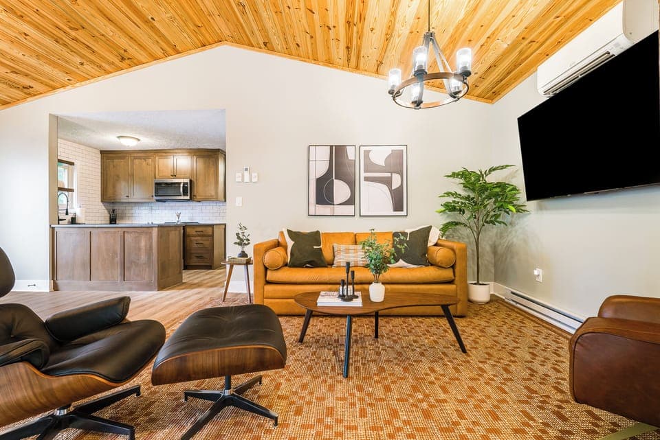 Relax with leather sofa, mid-century chairs & décor—comfort and style combined.