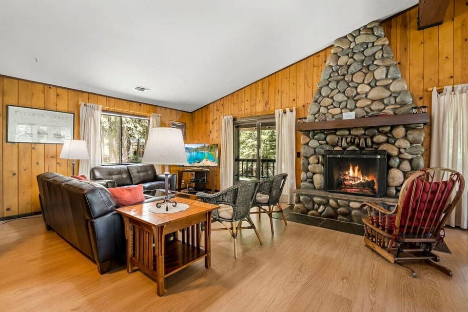 Large Open Great Room (Living Room / Kitchen / Dining) with Wood Burning River Rock Fireplace and Spacious Wrap Around Covered Deck!