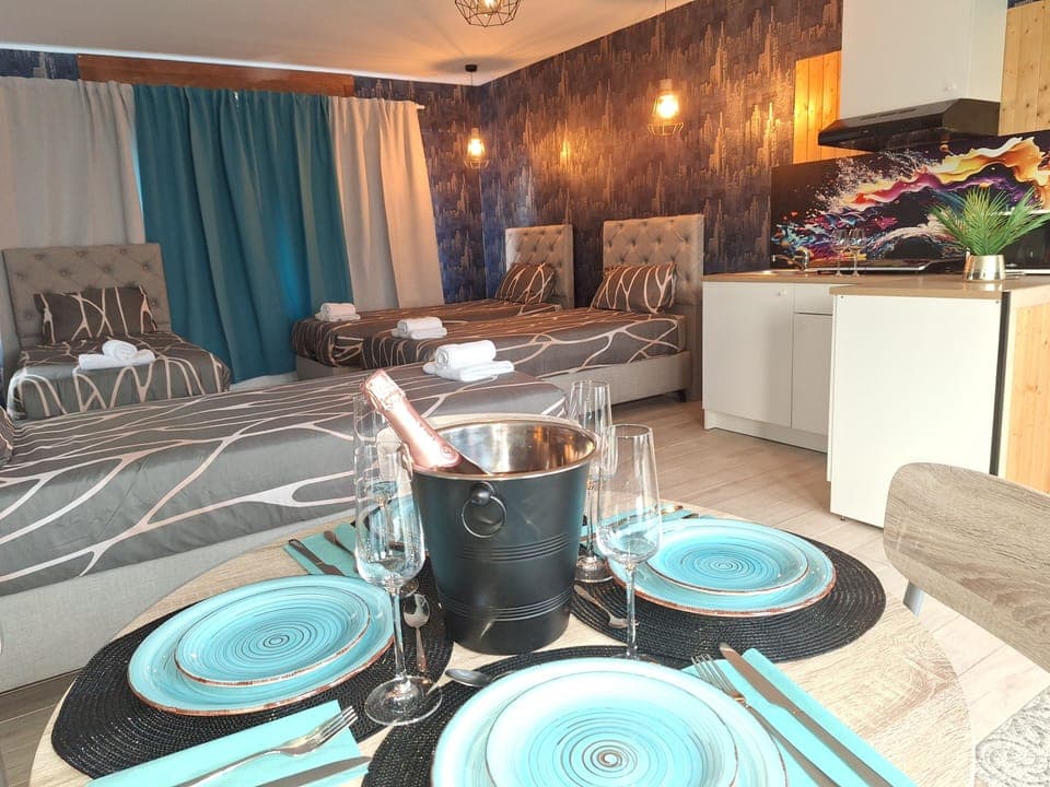 Deluxe Quadruple Room, Garden View | In-room safe, desk, laptop workspace, blackout drapes