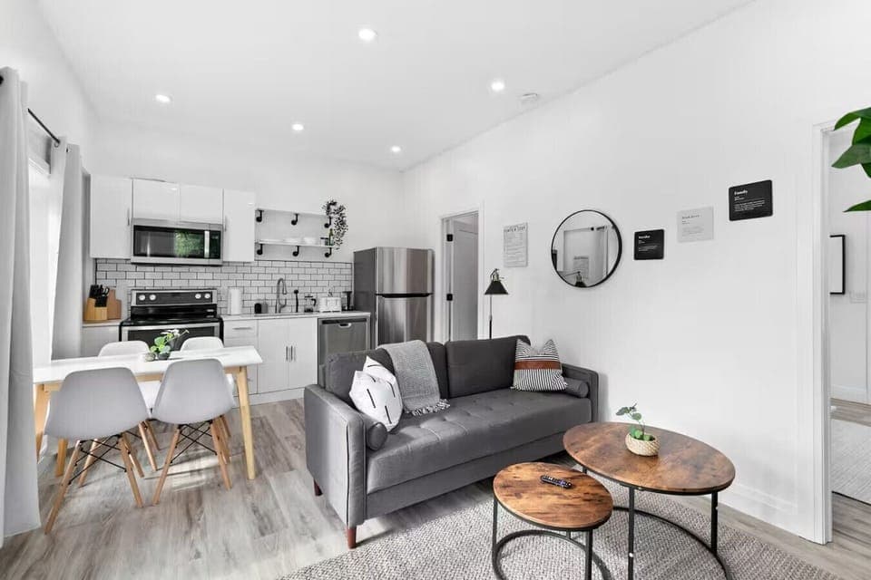 Spacious open-concept living and dining area featuring a vibrant sofa, modern furnishings, and a stylish entertainment setup—ideal for gatherings and relaxation.