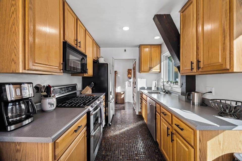 Galley kitchen with stainless steel appliances