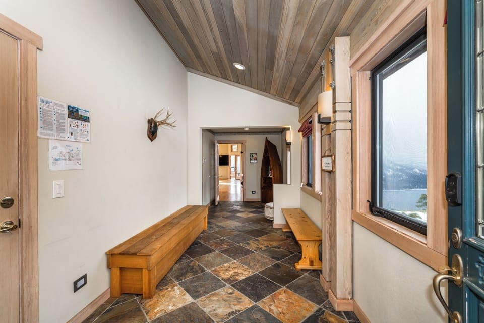 Front Foyer With Tile, Views, and Garage Door To Left