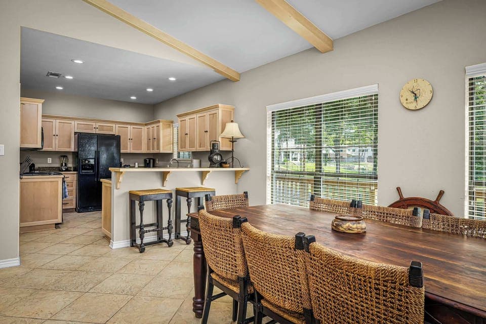 Open-concept kitchen and dining area perfect for gatherings, with a peaceful countryside setting.