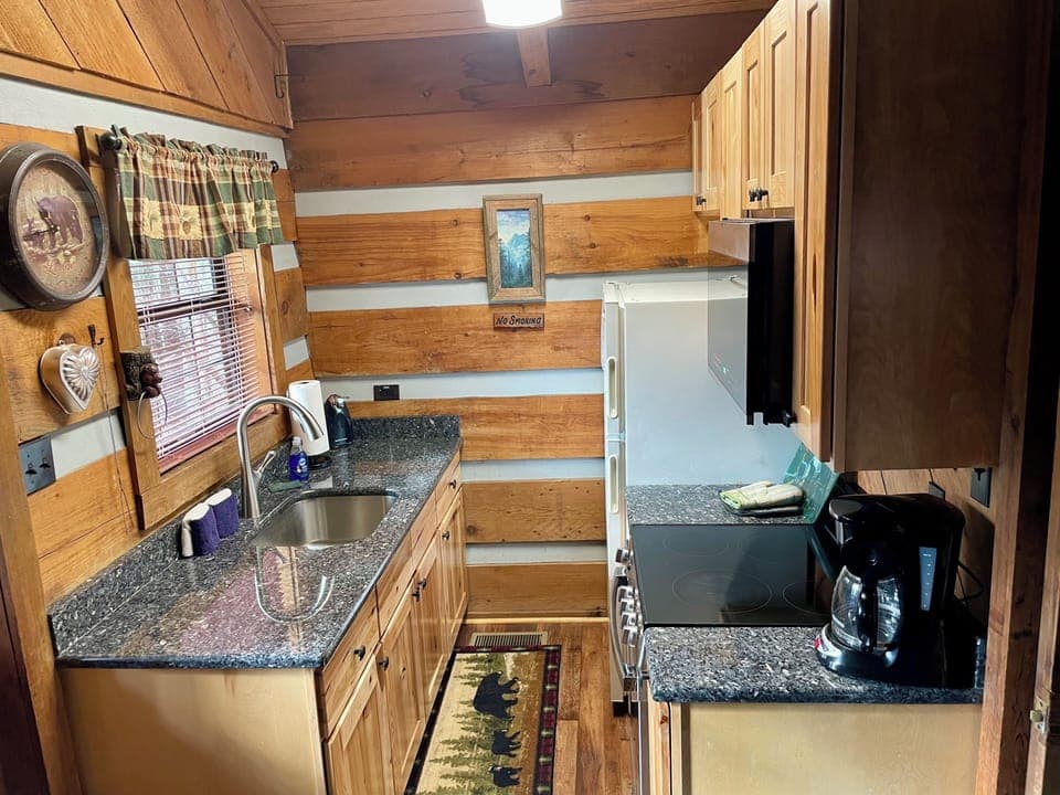Fully equipped kitchen includes a full sized refrigerator, stove/oven, microwave, toaster, and standard coffee maker
