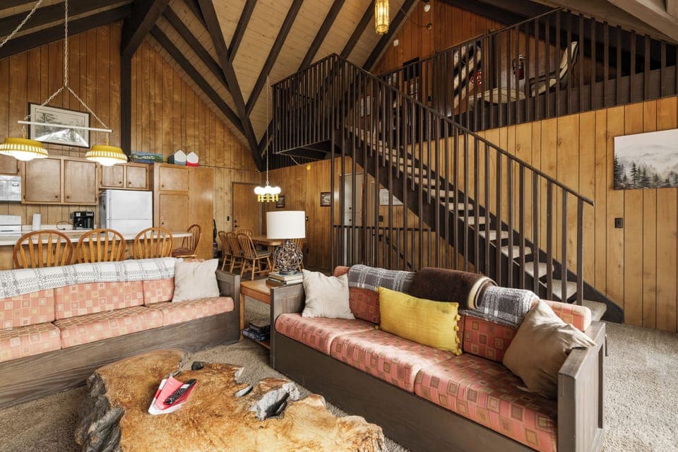 Upstairs Living Room - Upstairs living room with large windows facing lake. Smart TV and couches for comfort! Vaulted ceilings!  STAIRS to the LOFT