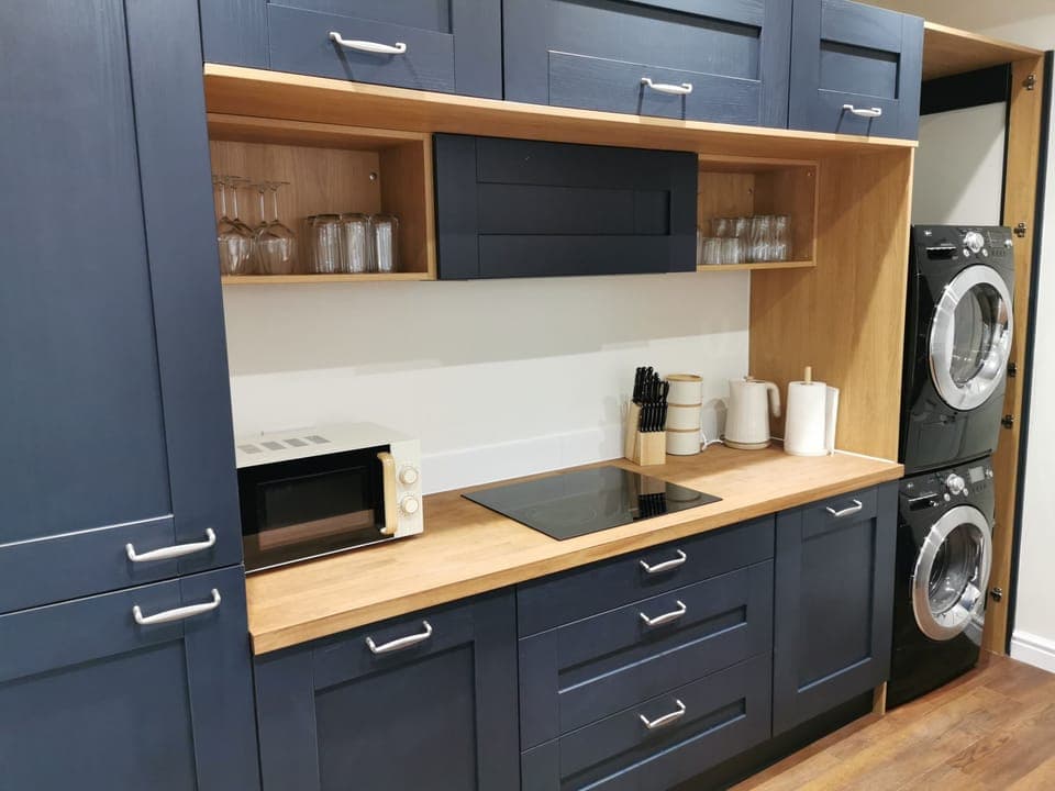 Kitchen showing hob, washing machine and tumble dryer