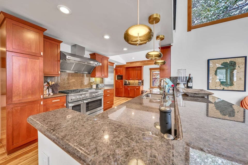 Kitchen: Drip coffee maker, Nespresso, Crockpot, blender, stand mixer, 2 sinks, food-warming drawers, 9-burner stove with griddle, double oven, sub-zero fridge, cooking utensils, tableware