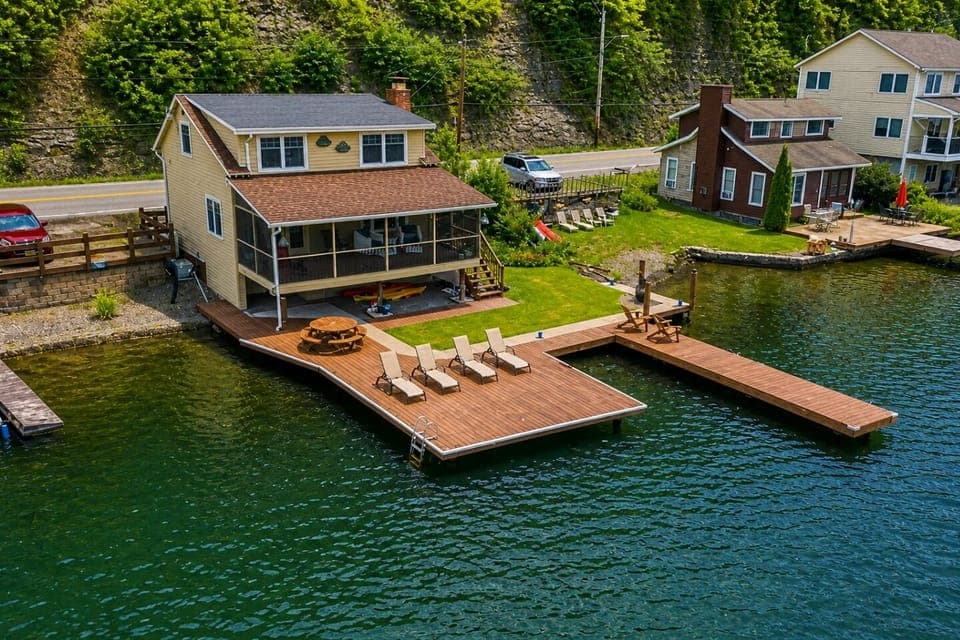 Nestled at the edge of a serene lake, this charming dock features a row of inviting, comfortable chairs, perfect for relaxing and enjoying the peaceful surroundings. The chairs, crafted from weather-resistant materials, are designed for comfort with 