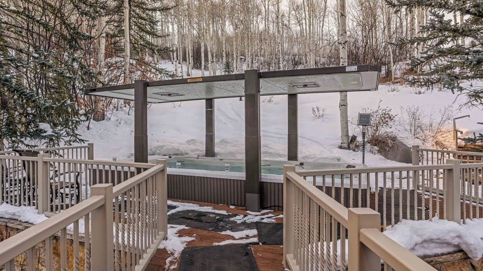 Infinity lap pool and hot tub spa on upper level