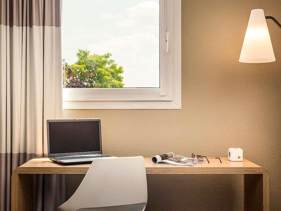 Premium bedding, desk, laptop workspace, blackout drapes