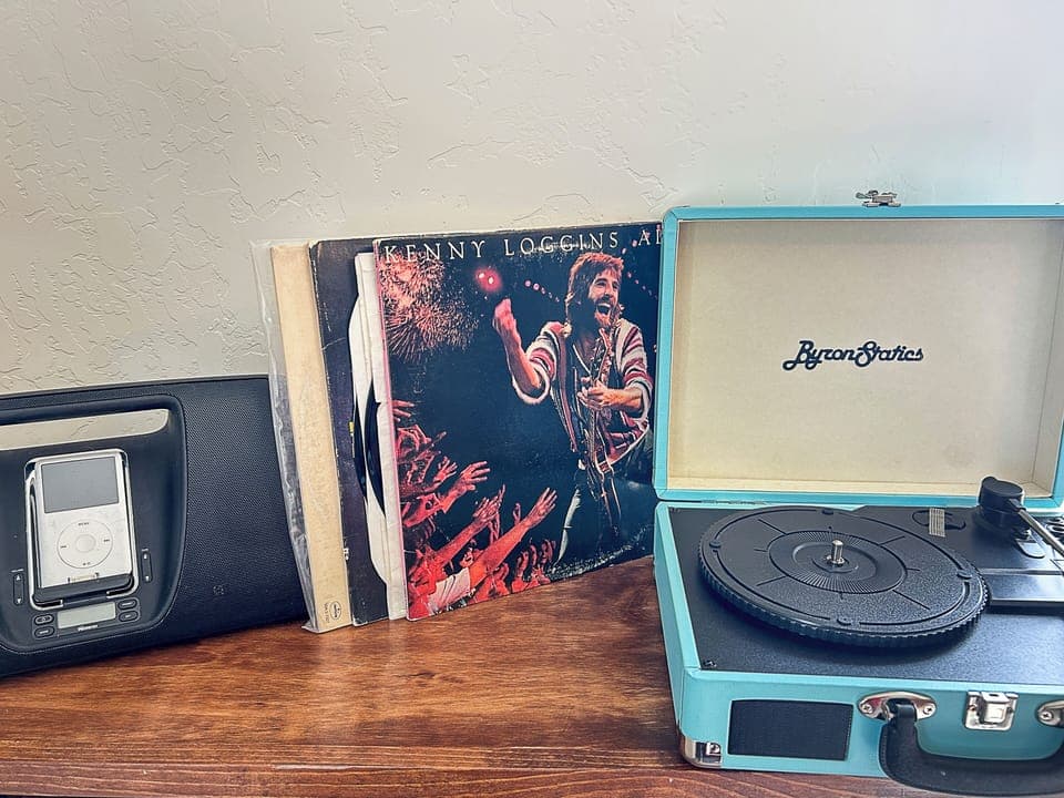 Spin your favorite vinyl on this vintage turntable while your phone charges nearby - perfect for cozy evenings in.