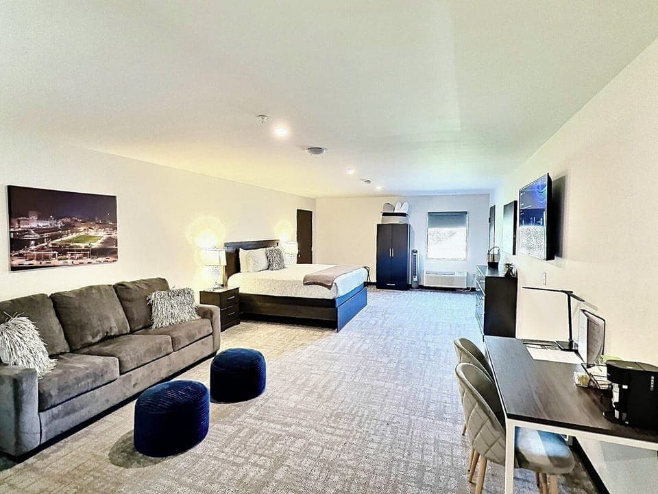 A bright and inviting room with a comfortable bed, soft linens, and ample natural light for a restful experience.