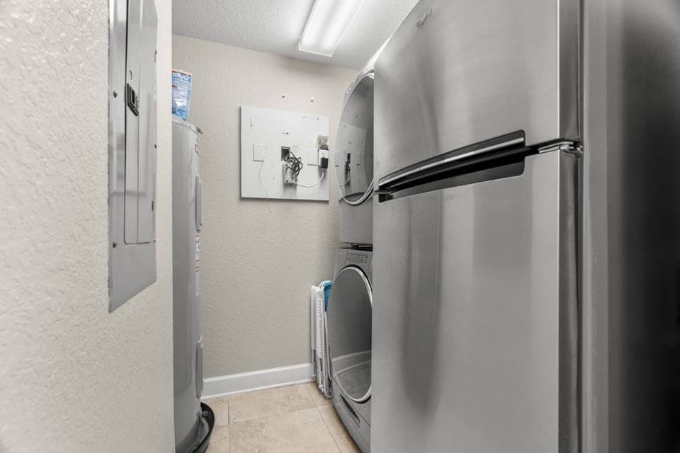 Laundry Room off of Kitchen with New Washer and Dryer and an Additional Stainless-Steel Refrigerator