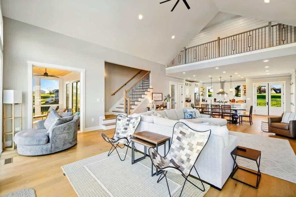 Spacious open-concept kitchen and living area with vaulted ceilings, modern fixtures, and abundant natural light.